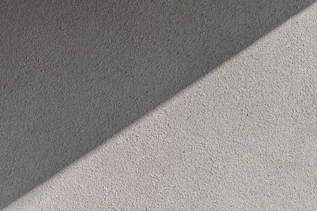 rough texture plaster on a wall of the hue sharkskin, shaded diagonallyの写真素材