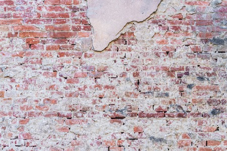 background texture old brick wall with remnants of plastersの写真素材
