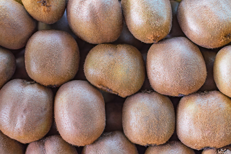 background texture of the folded kiwi fruit on the market counterの写真素材