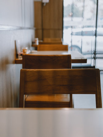 Wooden chairs in modern cafÃ© with blurred background and natural light