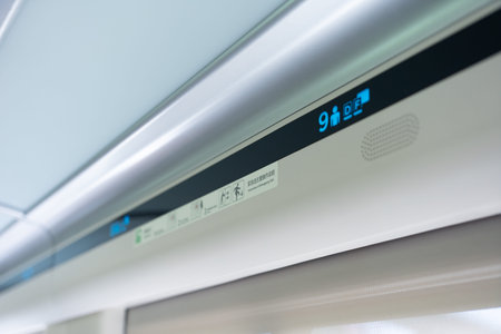 Digital display showing train car number 9 with accessibility and emergency icons on modern...