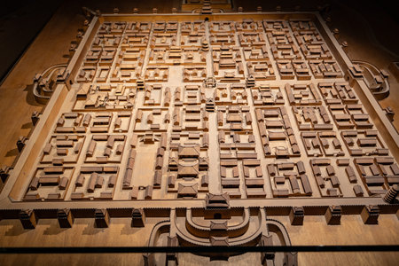 Ancient Chinese city layout model with detailed architecture and grid streets under warm lighting