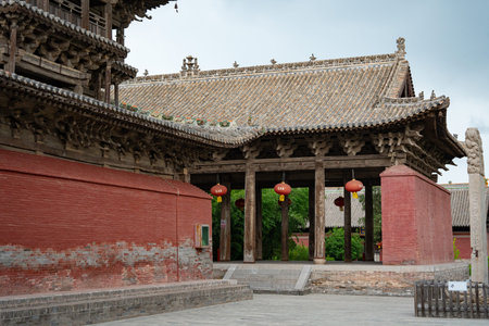 Traditional Chinese Temple Gate with Red Walls, Wooden Pillars, and Hanging Lanterns Under Gray Tile...