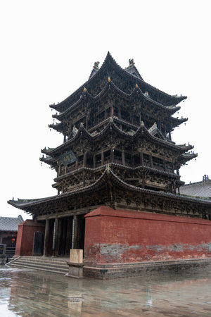 Traditional Chinese Temple Tower with Multi-tiered Roofs on Wet Stone Ground