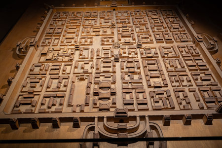 Wooden model of ancient city layout with detailed buildings and streets under warm lightingの写真素材
