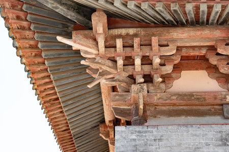 Traditional Chinese wooden bracket set under tiled roof with intricate architectural details