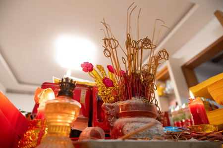Chinese Temple Altar with Incense Sticks, Candles, and Red Decorations in Traditional Ritual Setup
