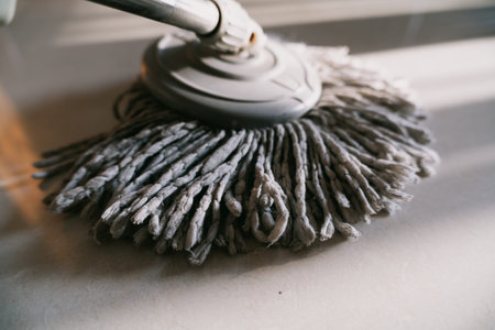 Close-up of a mop head on a clean floor, indoor cleaning scene in a modern home