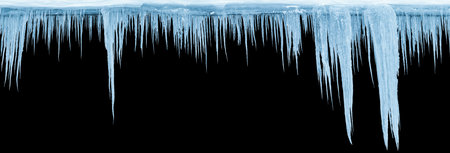 Icicles on an black background, isolated object. Panoramic photo.の写真素材