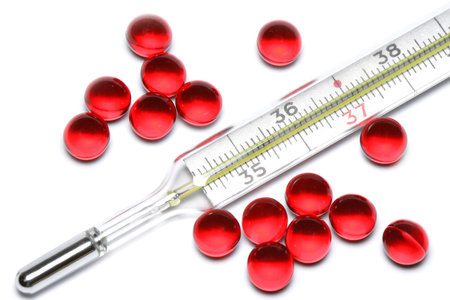thermometer and pills on white background