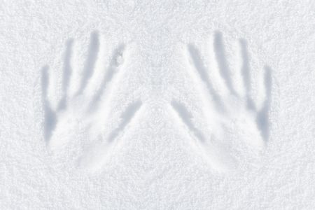 hands impression in fresh snowの写真素材