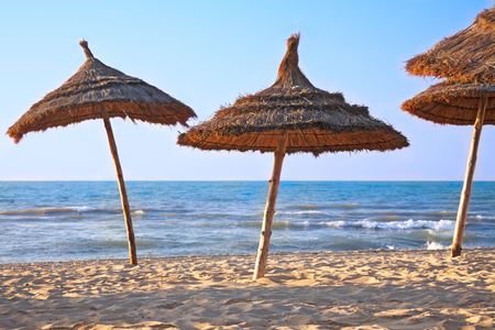 thatched sunshades on the beachの写真素材