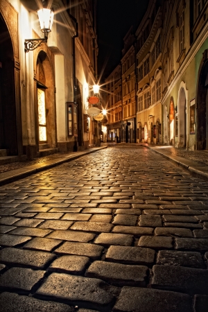 narrow alley with lanterns in Prague at nightの写真素材