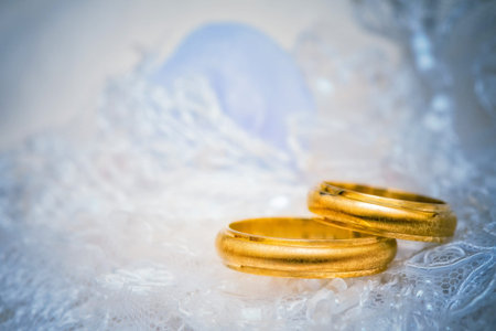golden wedding rings on lace