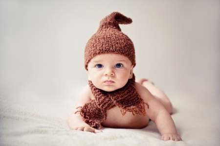 newborn baby in a cap and scarfの写真素材