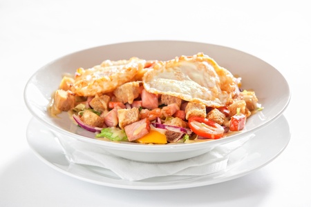 salad with vegetables, bacon and fried eggsの写真素材