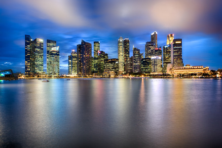 Singapore city skyline at night with reflectionの写真素材