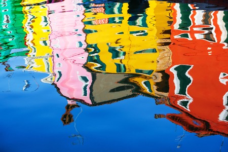 Reflection of a colorful houses in water canal, Burano island, Venice, Veneto region, Italyの写真素材