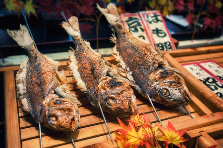 Grilled fishes on sticks as street food at Nishiki market in Kyoto, Japanの写真素材