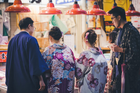 Kanazawa, Japan - November 14, 2018: Two japanese couples in traditional kimono at Omicho Ichiba...
