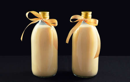 Two bottles of homemade eggnog on dark backgroundの写真素材