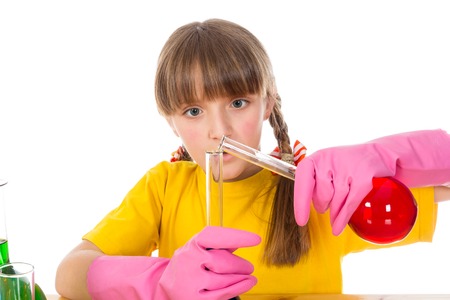 Interested girl is mixing solution. Isolated on white backgroundの写真素材