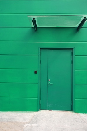 image of green single door against green wall  のeditorial素材