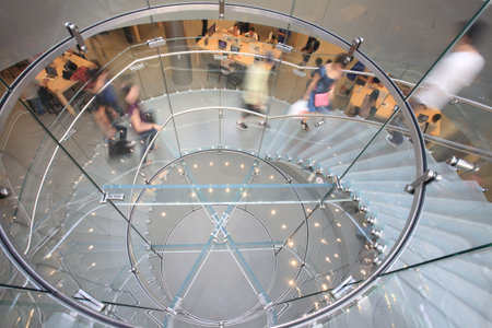 modern glass spiral staircase in shop with motion step