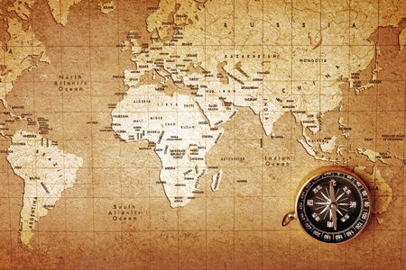 An old brass compass on a Treasure map background のeditorial素材