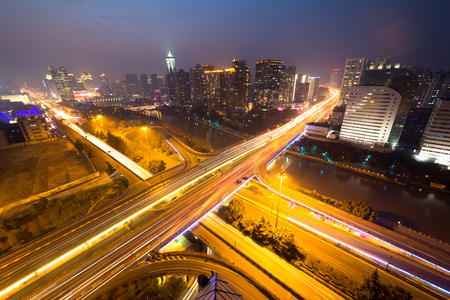traffic light trails on overpass and cityscape at nightのeditorial素材