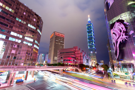 Busy traffic light trails in modern street and illuminated landmark of taipei at nightのeditorial素材