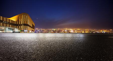 Empty asphalt road and modern skyline at nightのeditorial素材