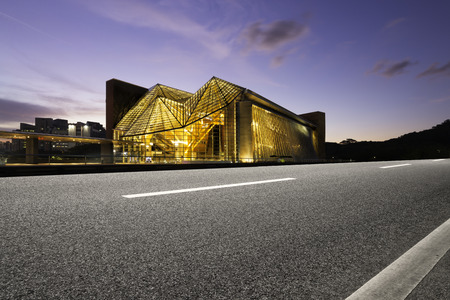 Illuminated modern building exterior and  empty streetのeditorial素材