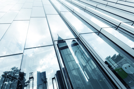 a skyscraper with glass walls and the reflection of landmarks on the opposite sideのeditorial素材