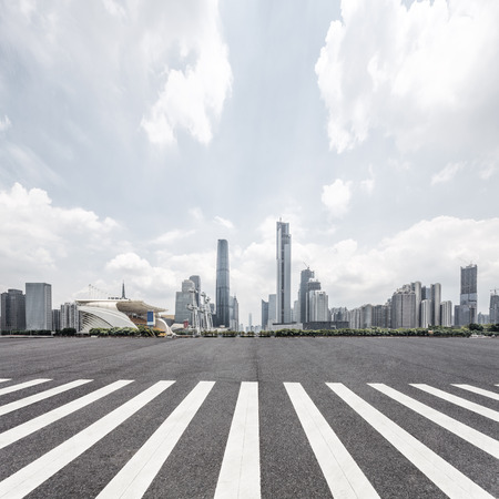empty road with zebra crossing and skyscrapers in modern cityのeditorial素材