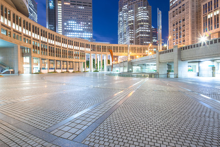 empty pavement before modern office buildings built in downtown of tokyo at nightのeditorial素材