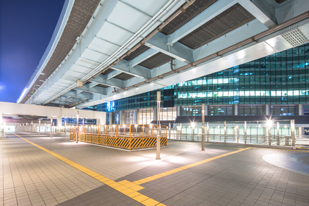 modern office buildings at night in tokyo on view from empty streetのeditorial素材