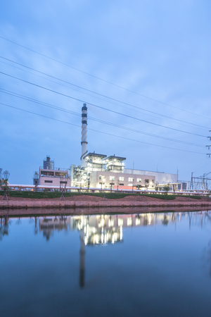 modern power station near river at twilightのeditorial素材
