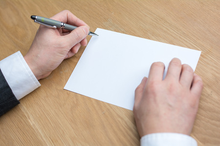 businessman writing on white paperのeditorial素材