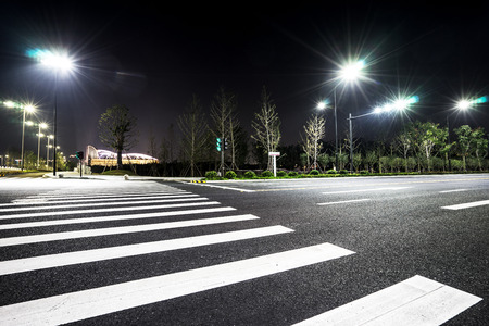 empty asphalt road with illuminated lights in suburb of seoul at nightのeditorial素材