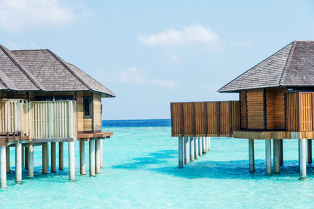 landscape of tropical sea with resort house in sunny blue sky