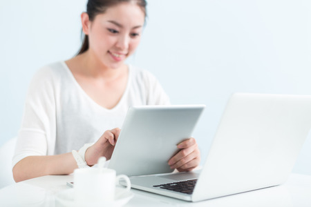 young pretty chinese woman working with laptop in officeのeditorial素材
