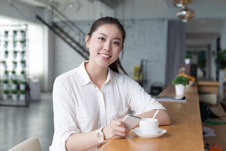 young beautiful chinese woman relaxing in officeのeditorial素材