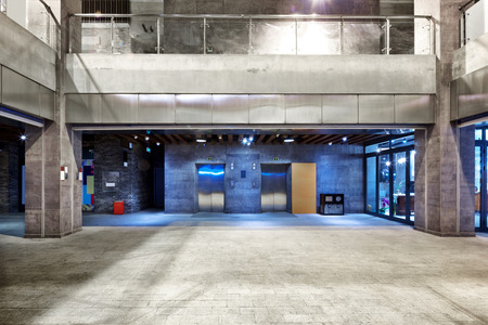 modern buildings in modern city at night from empty footpathのeditorial素材