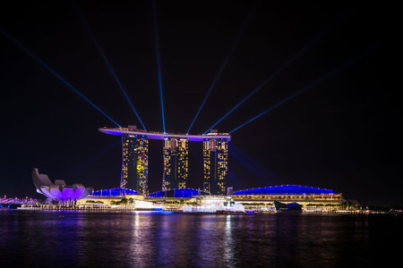 landmark modern building near river in singapore at nightのeditorial素材