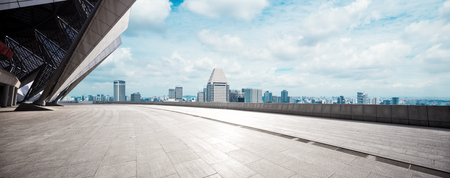 cityscape of modern city from empty brick floor in cloud skyのeditorial素材