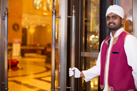 young indian porter service in luxury hotel lobbyのeditorial素材