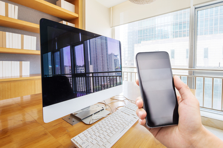 smart phone in modern meeting room with computer on tableのeditorial素材