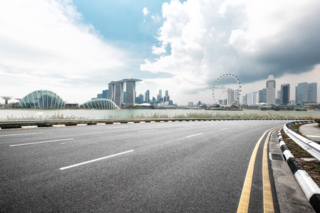empty asphalt road and cityscape of singapore in blue skyのeditorial素材