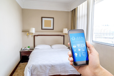 smart phone with smart home app and modern bedroomのeditorial素材